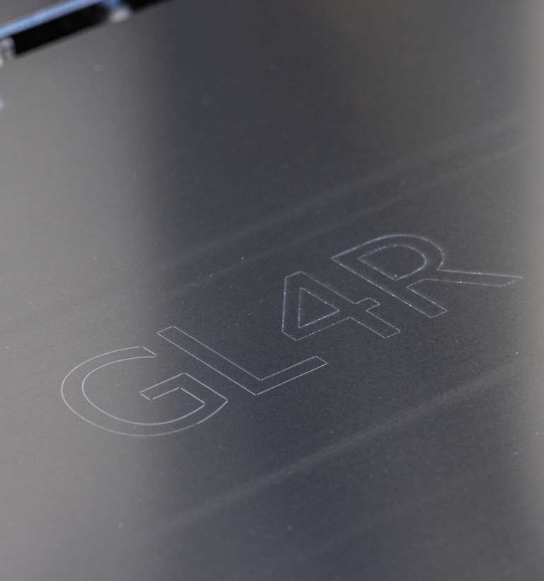 A sheet of metal with 'GL 4R' engraved on it.