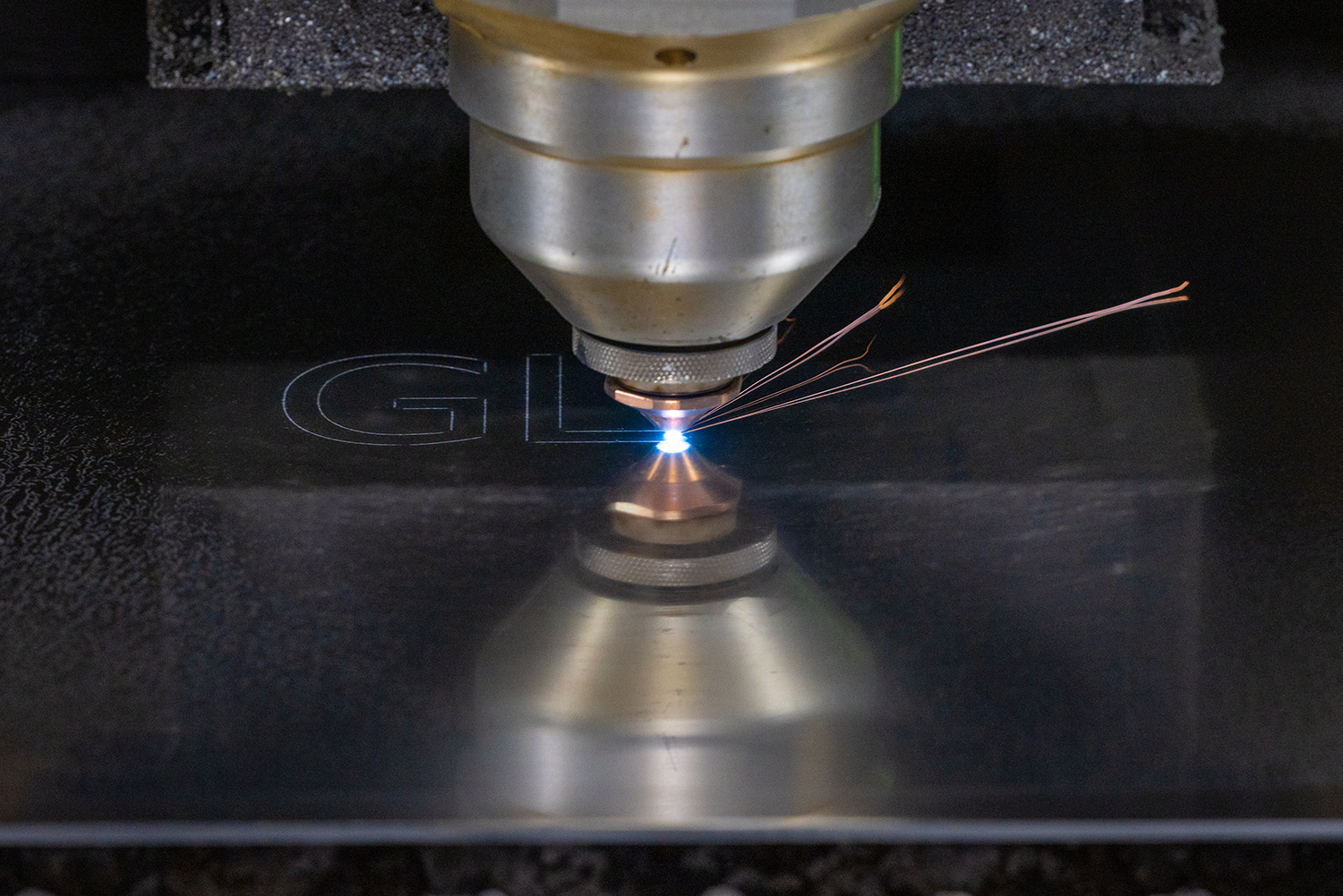 A laser engraving onto a sheet of metal.
