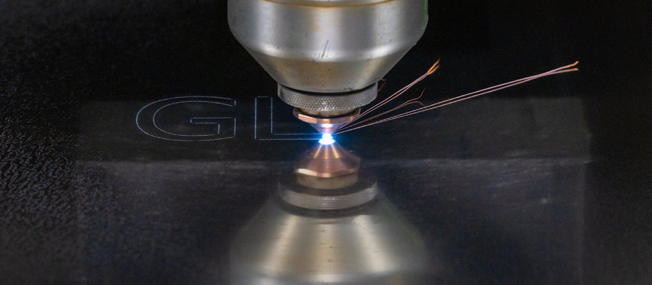 laser cutting machinery cutting a metal sheet with bright sparks