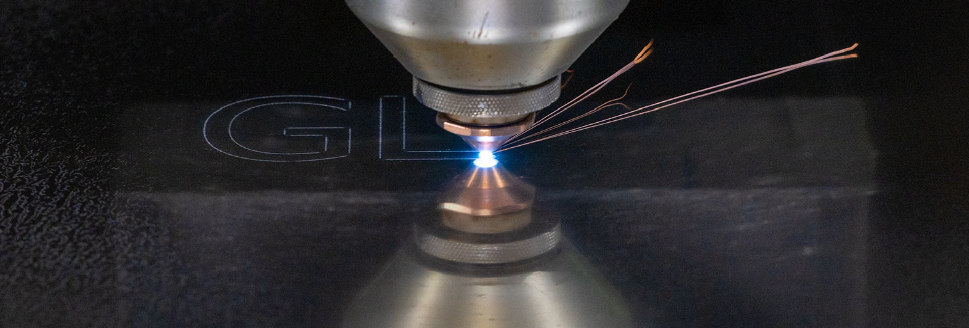 laser cutting machinery cutting a metal sheet with bright sparks
